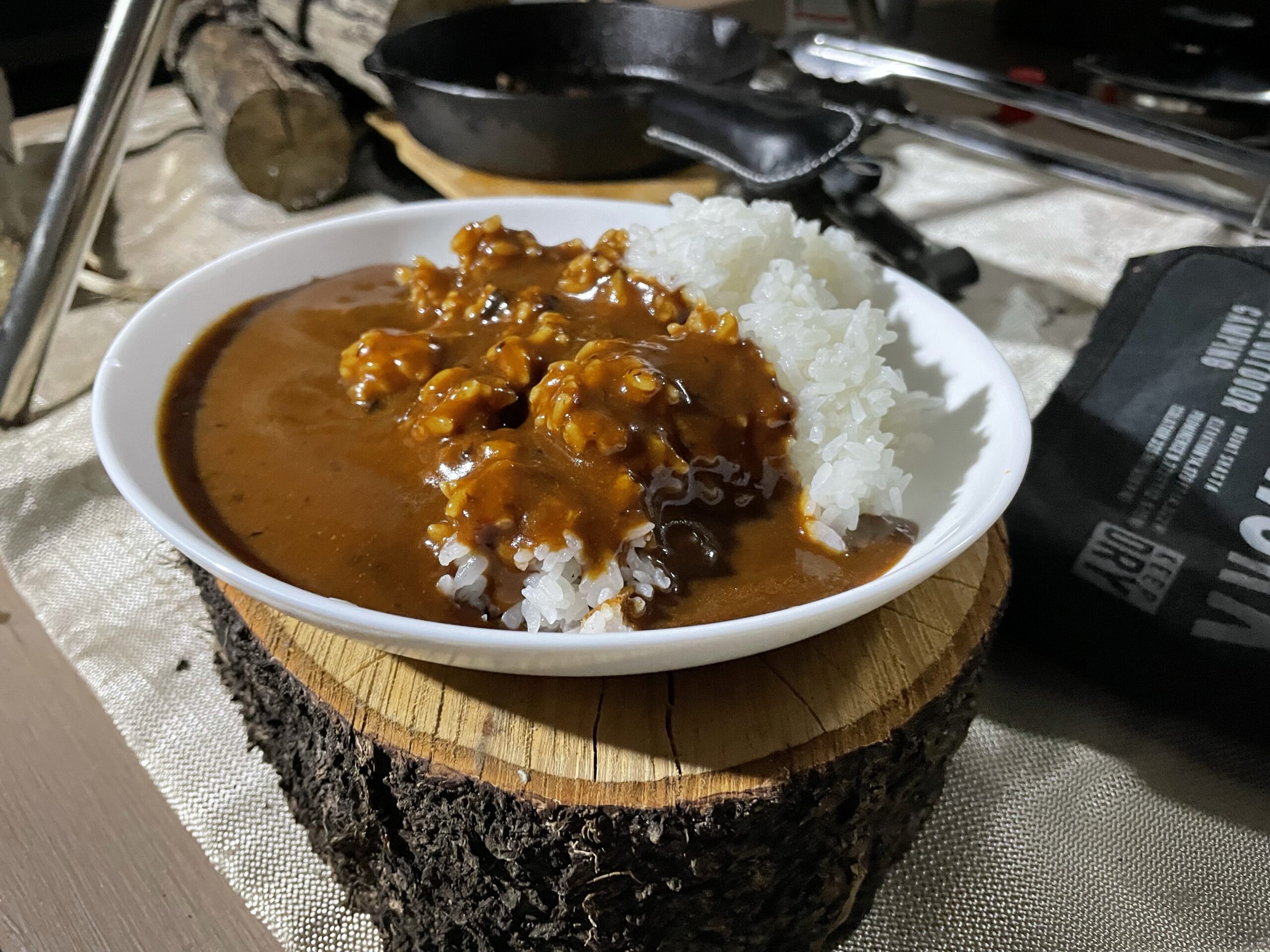 薪の台に載せたカレーライスの皿